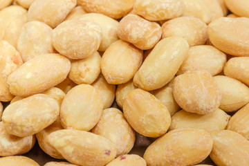 Background of roasted salted peanuts closeup at selective focus
