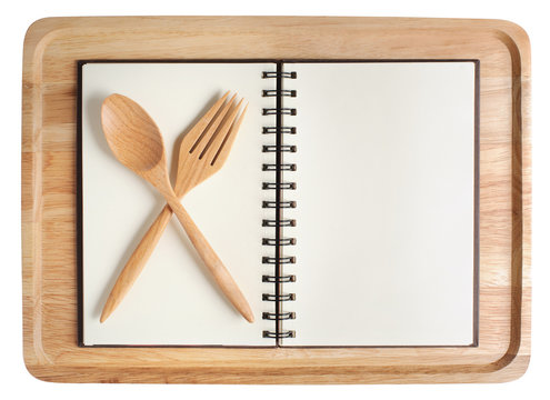 wood plate and empty open notebook with spoon frok