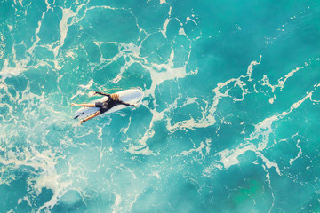 Surfer in the calm ocean, top view