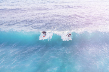 Two surfers in the ocean, top view