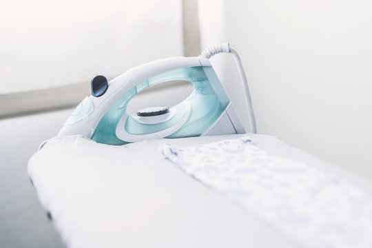 Steam Iron On Ironing Board