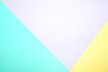 Fashionable  pastel colored paper flat lay top view, geometric background texture, pink, purple, yellow, beige, green and blue.