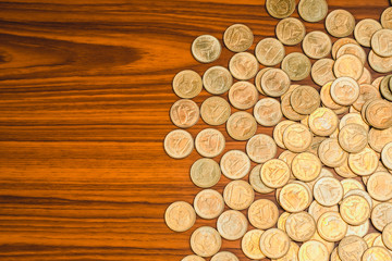 Stack of coin on wooden working table, business and finance concept.