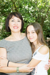 cheerful mother with cute daughter in park summer