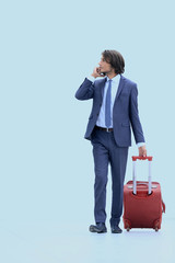 successful businessman with Luggage talking on the phone.