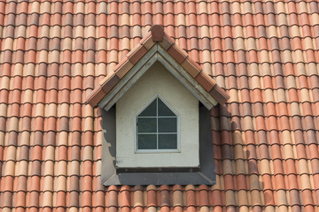 Tile laid in rows as a roof element with window