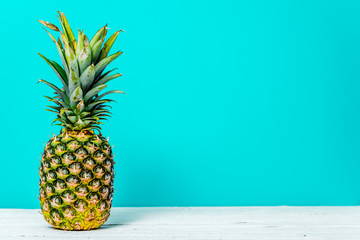 Ripe pineapple isolated on blue background