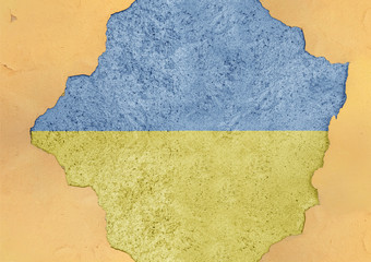 Ukraine flag painted on concrete hole and cracked wall facade structure