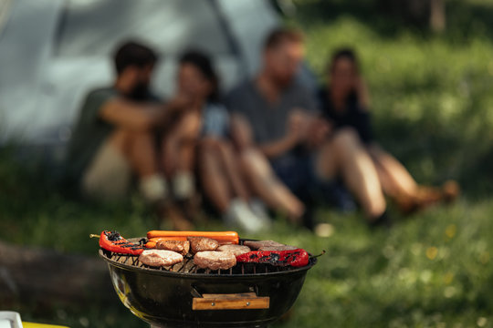 Delicious food and good friends - a man in a black shirt and a woman in a white shirt are sitting on