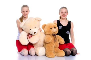 Girls with a teddy bear.