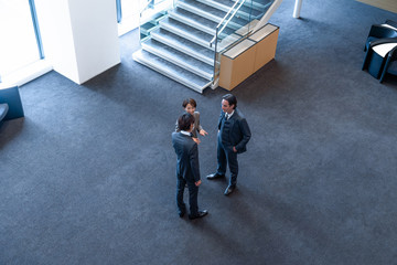 Group of businessperson talkng in the hall.