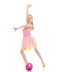 Naklejka premium Girl gymnast performs exercises with the ball.