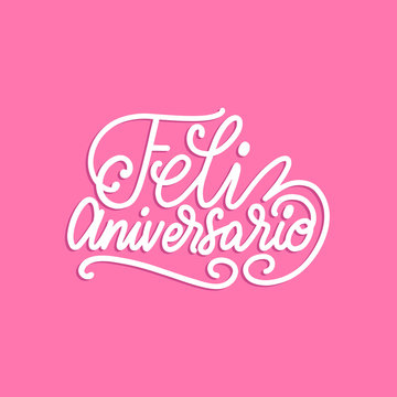 Feliz Aniversario translated from Spanish handwritten phrase Happy Anniversary on pink background.Vector illustration.
