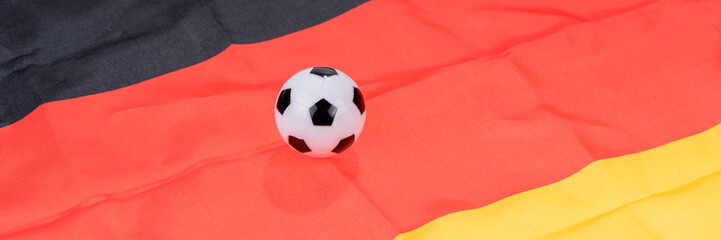 Fototapeta premium Football on Germany flag background. Football and Soccer Games
