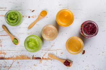 Obraz na płótnie Canvas Colorful baby food purees in glass jars