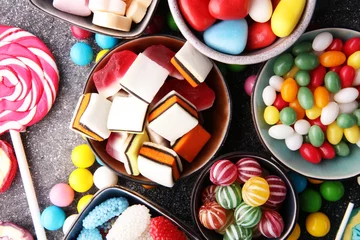 Fotobehang candies with jelly and sugar. colorful array of different childs sweets and treats © beats_