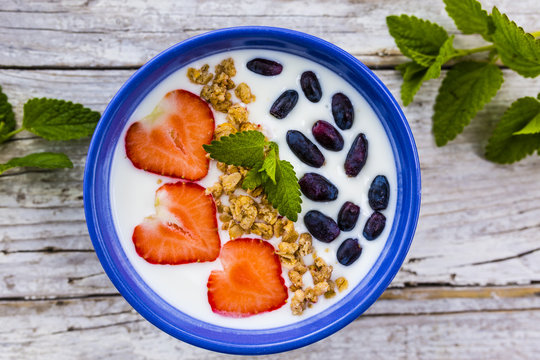 A delicious and healthy breakfast of yogurt with fresh fruit.
