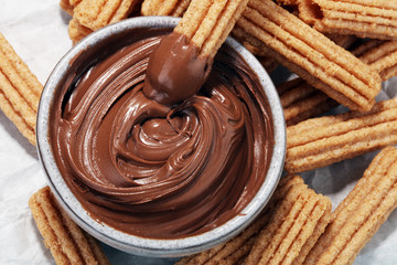 Traditional Spanish dessert churros with sugar and chocolate