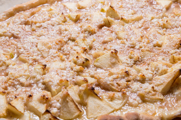Apple pie on kitchen table, textured surface