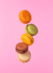 Colored macarons flying in freeze motion