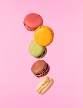 Colored macarons flying in freeze motion