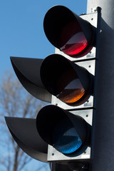 Modern traffic light on a sunny day with blue sky as background