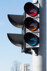 Modern traffic light on a sunny day with blue sky as background