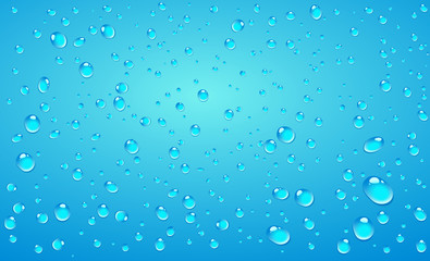 Vector water drops on blue lighted background.