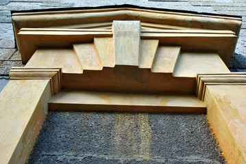 A false arch in white and yellow color palette on a gray cement wall, architectural detail horizontal background