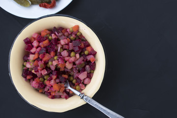 Traditional Russian salad vinaigrette on a gray background and copy space.
