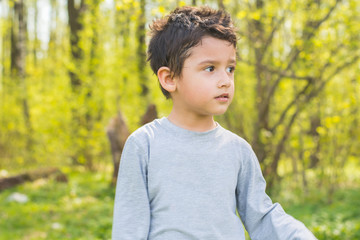 dark-haired boy in a forest