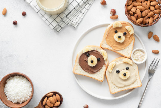 Animal Face Breakfast Toasts With Nut Butter For Kids On Concrete Background With Copy Space For Text. Food Art, Kids Menu Or Healthy Vegan Snack For Children Concept