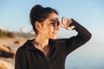 Smiling young sportsgirl at the seaside