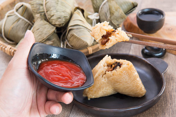 A man is going to eat zongzi or rice dumpling on Dragon Boat Festival, Asian traditional food