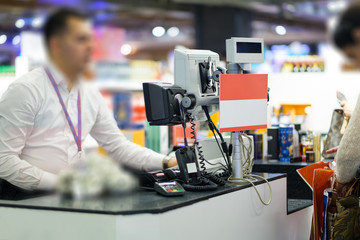 Istanbul, 01 may 2018: Cash desks with cashier serves customers on blurry background, Turkey