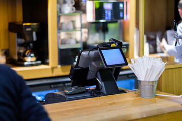 Cash desk terminal with screen in small cafe