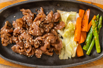 sliced pork steak on hot plate
