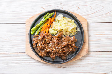 sliced pork steak on hot plate