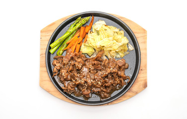sliced pork steak on hot plate
