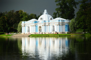 A blue pavilion and reflection in the water in the park of Tsarskoe Selo