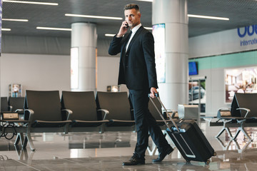 Serious mature businessman talking on mobile phone