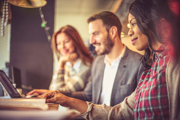 Tree young colleagues at cafe.