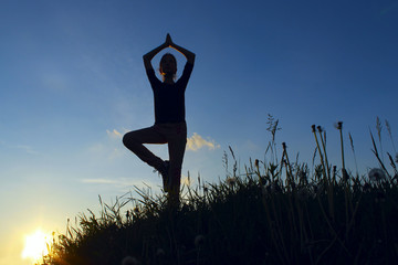 Teenage Girl In A Balancing Yoga Position.  Young Girl In Tree Pose Position, Outdoors.