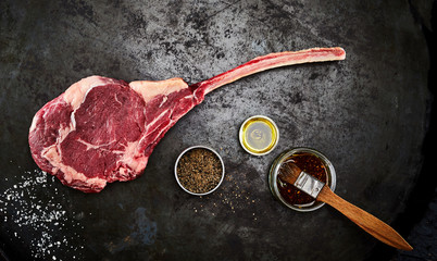 Tender raw trimmed bone-in ribeye steak