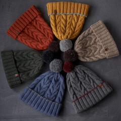 many colorful hats on a gray background