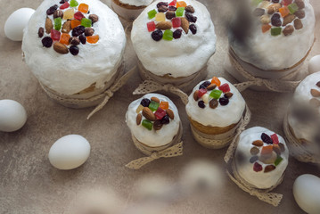 Easter cake and eggs on the brown texture background. Copy space. Top view