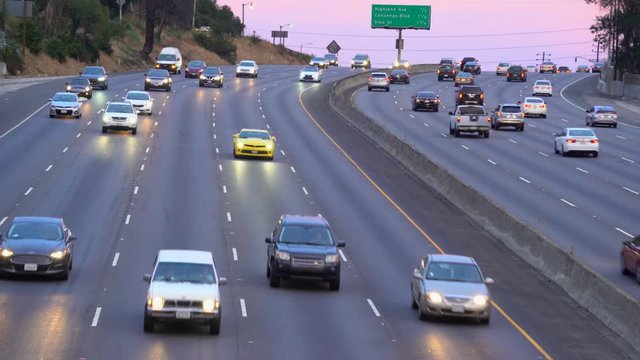 Aerial of heavy traffic on Hollywood freeway at sunset.