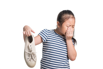 Asian kid girl age 7 year hold stinky shoe on white background
