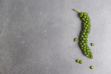 Fresh black pepper on rock background