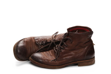 Old pair of brown shoes, isolated on white background